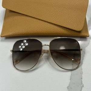 Oversized aviator sunglasses by Zimmermann.